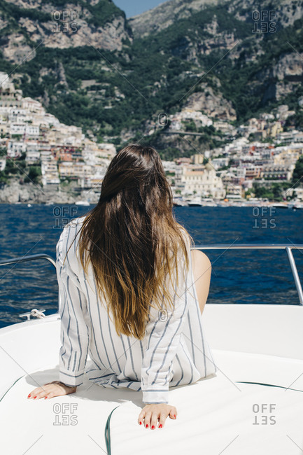 Woman lounging on a boat off Italian coast