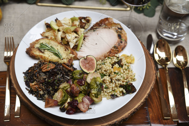 Close up of plate of food served at a rustic holiday dinner party