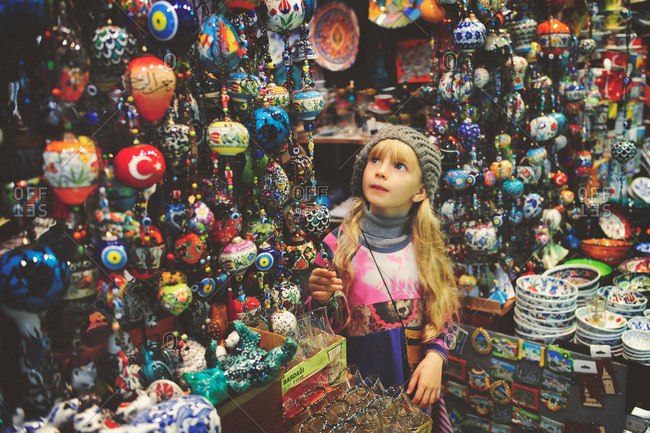 Girl looking at decorations in Turkish market