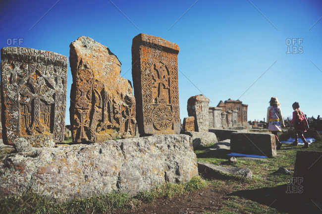 Girls exploring traditional Armenian graveyard