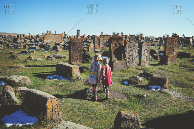 Girls exploring traditional Armenian tombstones