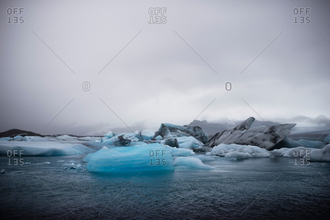 Ice bergs under a cloudy sky