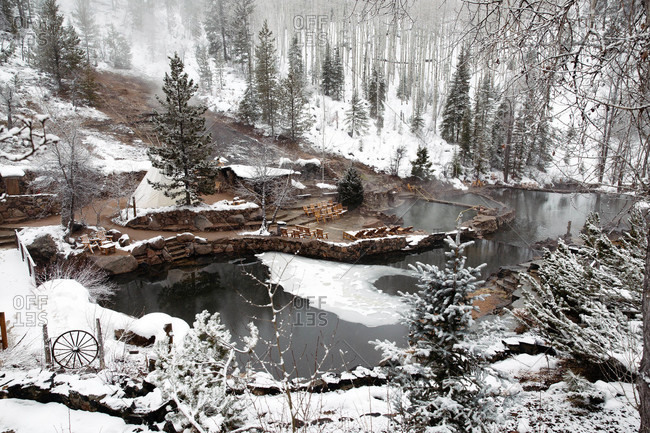Thermal pool swimming area with rock walls in winter