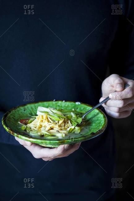 Man holding Japanese noodle dish