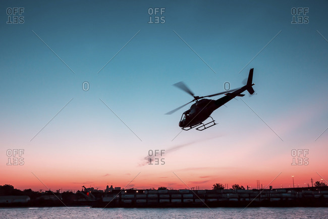 Helicopter taking off at sunset, New York City, NY