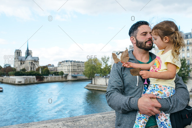 Dad holding girl by the Seine, Paris