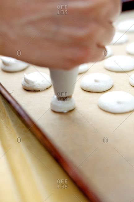 Piping macaron dough onto baking pan