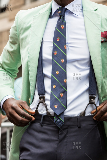 Man in a mint green blazer and suspenders