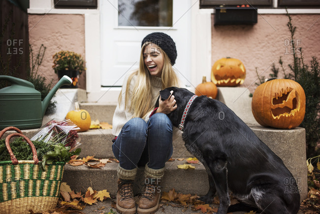 Woman being greeted by dog after coming home from market