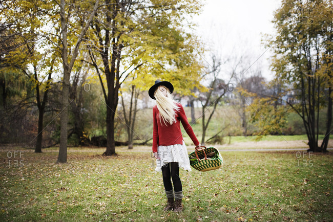 Young woman with a market basket in autumn