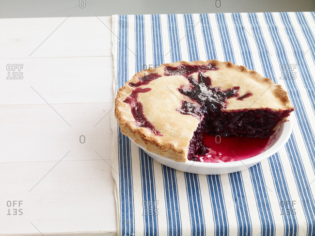 Blackberry pie with a slice missing