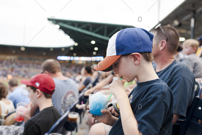 Boy with a snow cone at a baseball game