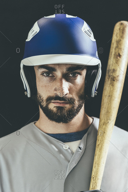 Portrait of a baseball player standing with a baseball bat