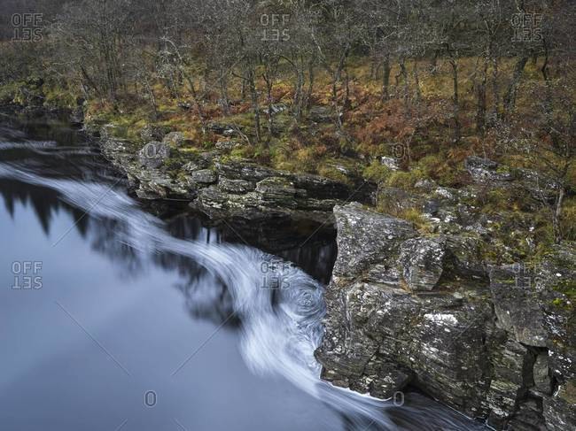Swirling water and river bank in the Orchy River Valley in Scotland