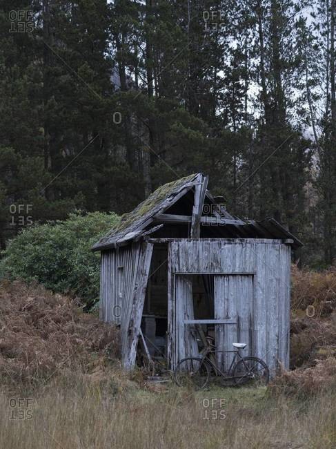 Abandoned building and rusted bike in Loch Etive, Scotland