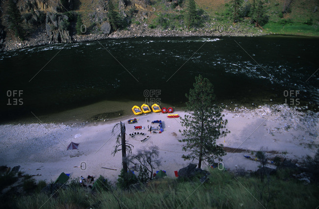 Inflatable boats on the beach of a rushing river