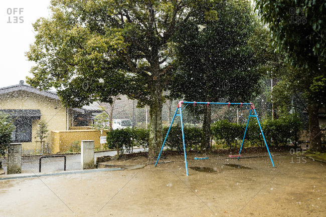 Snow falling over a playground in Kyoto, Japan