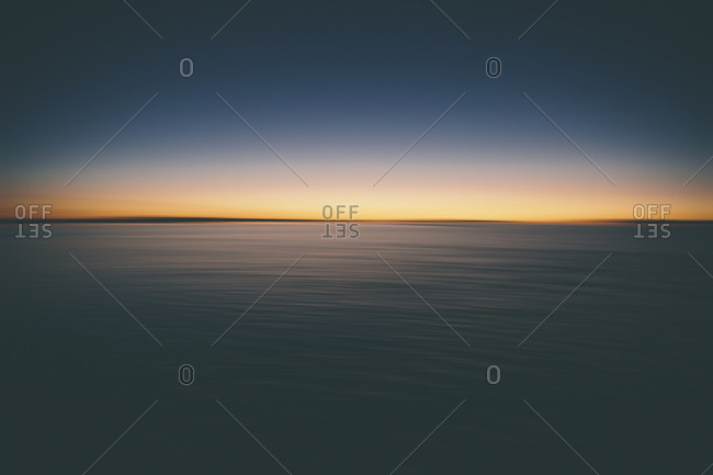 The view across the surface of Bonneville Salt Flats to the sunrise dawn light