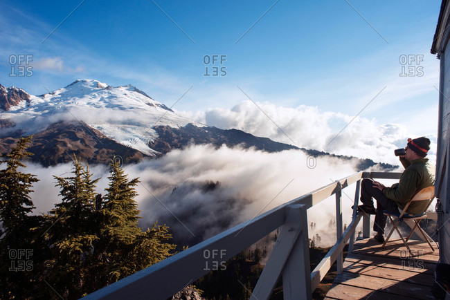 Man on deck overlooking snowy mountains