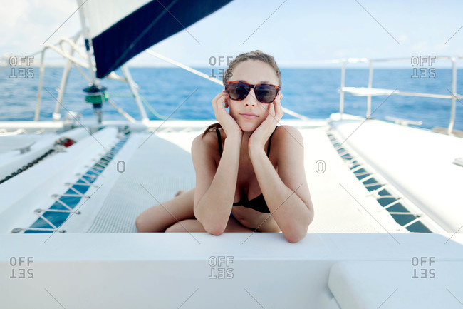 Woman lounging on sailboat trampoline
