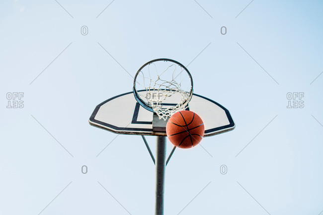 Basketball making a basket through the hoop