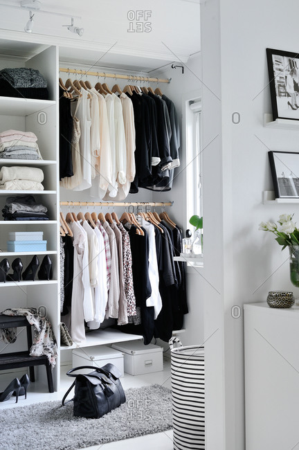 Neutral clothing in a  modern closet