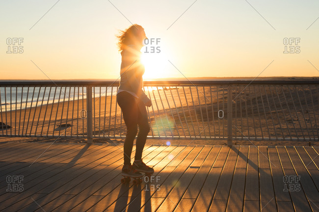 Woman roller skating on a pier at the beach