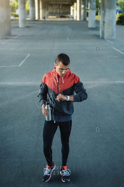 Man checking time while standing on street