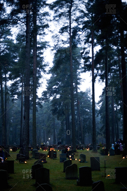A cemetery with lit lights