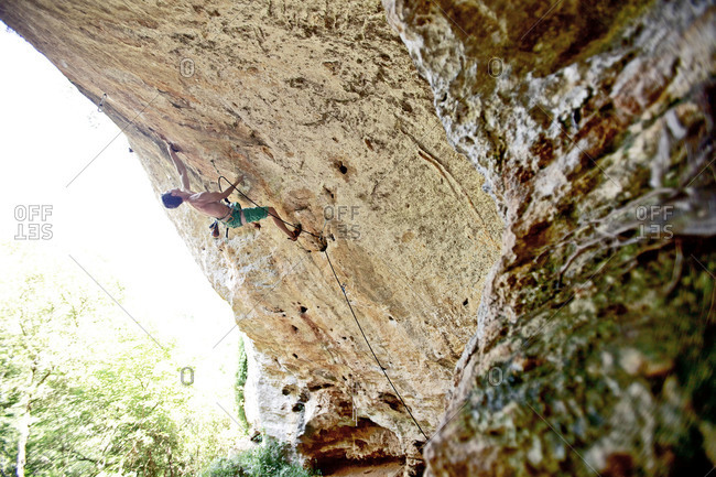 Man climbing rock face in Italy