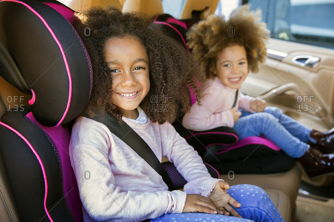 Girls sitting together in car seats