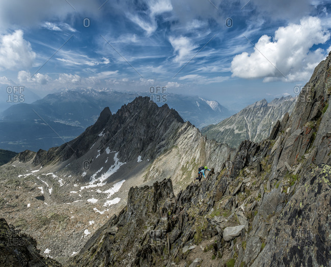A person climbing Wiwannihorn mountain in Switzerland