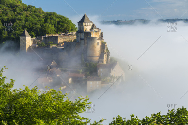 French castle shrouded in morning mist