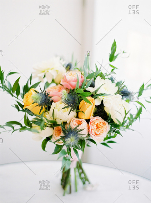 Wedding bouquet of yellow, pink and white flowers on table
