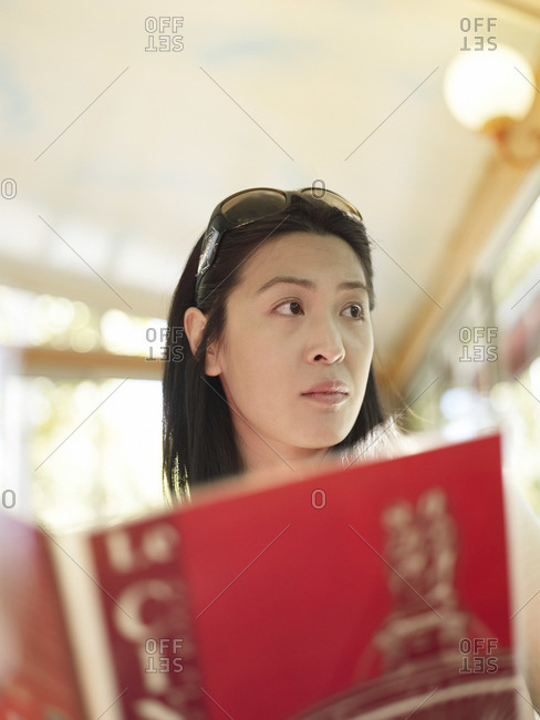 Woman distracted from a menu at a restaurant