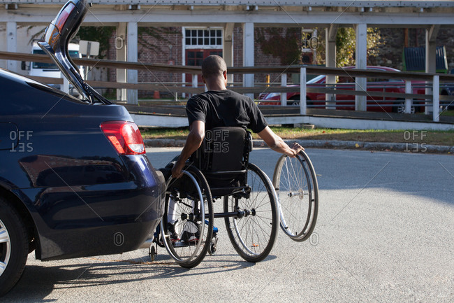 Man who had Spinal Meningitis in wheelchair entering his accessible vehicle