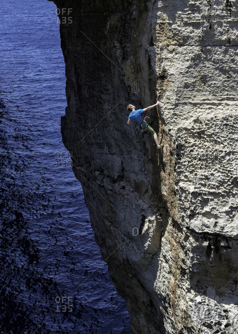 Rock climber in Gozo Dwejra