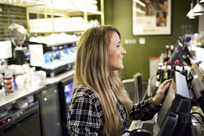 Concession stand worker smiling at register