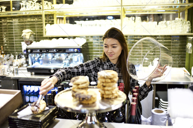 Woman serving pastry at theater concession stand