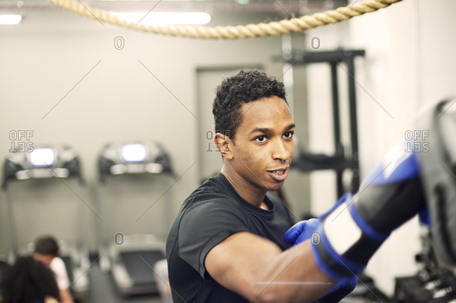 Young man boxing in his company\'s gym