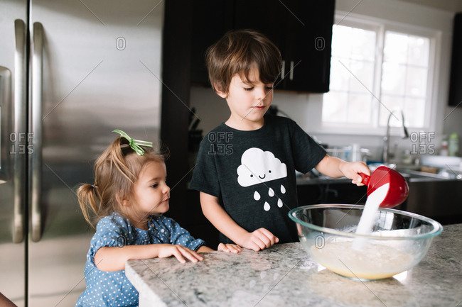 Brother and sister mixing cookie ingredients together