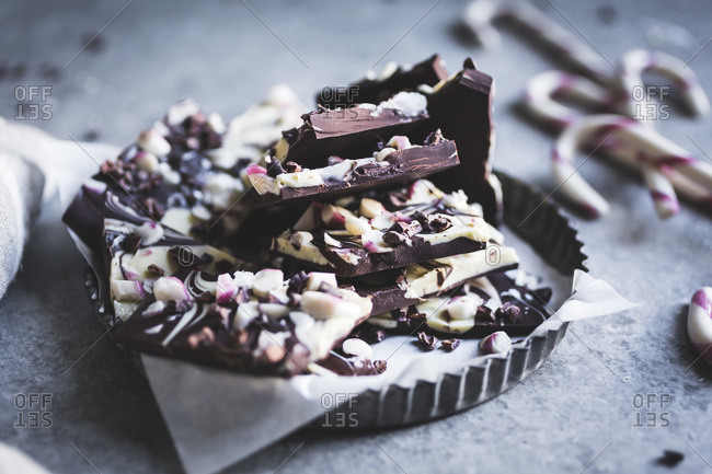 Close up of all-natural dark chocolate peppermint bark with cacao nibs and flaky salt