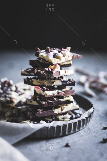 Stack of all-natural dark chocolate peppermint bark with cacao nibs and flaky salt