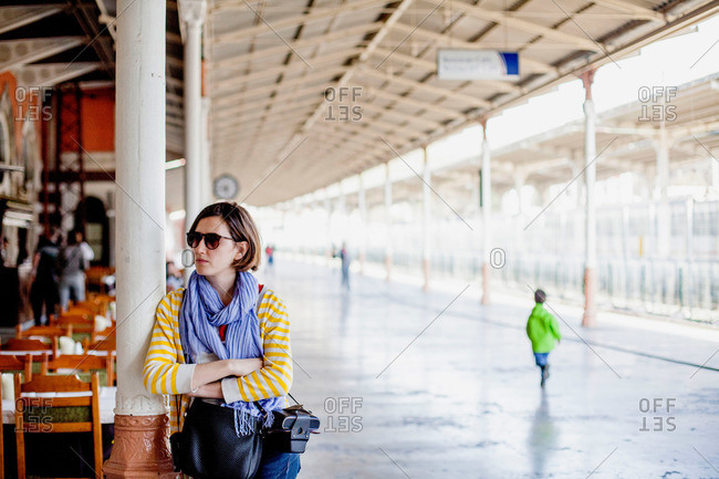 Young woman leaning on a column at Sirkeci Train Station, Istanbul