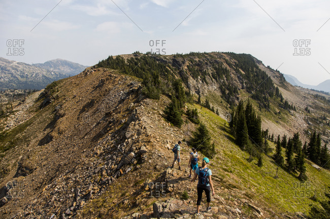 Group of hikers climbing on a rocky mountain ridge