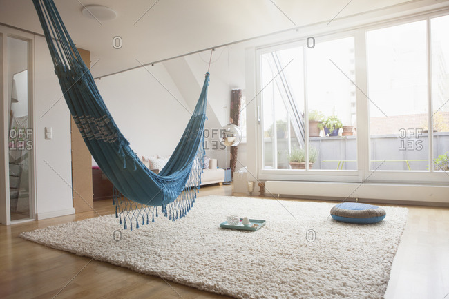 Home interior with hammock and carpet