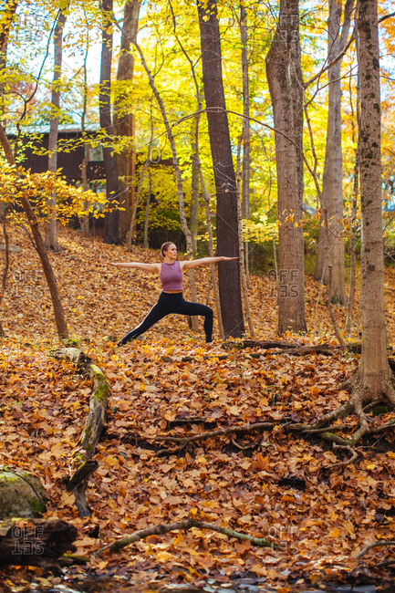 Woman doing yoga in the woods