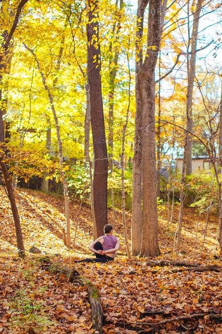 Woman stretching during yoga in the woods