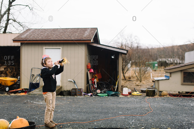 Child blowing horn to celebrate the new year