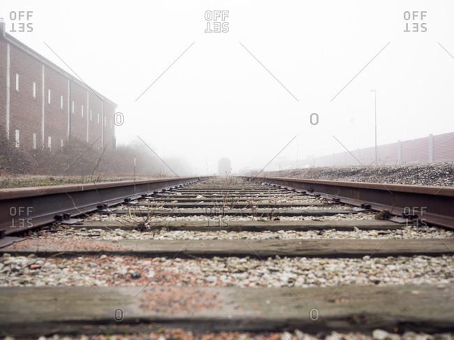 Low angle view of train tracks on a misty day